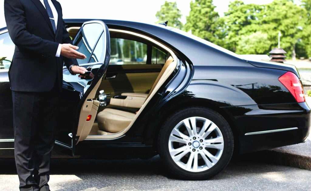 Las Vegas chauffeur service given by the chauffeur who unlocks the limousine entrance for the client in order to go on a luxurious journey.