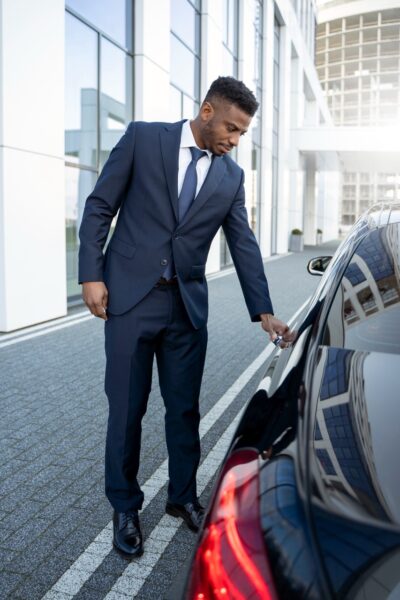 Elegant man opens the door to a stretch limo. He is a Las Vegas chauffeur. Photo from freepik.com